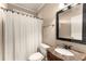 Bathroom featuring framed mirror, marble countertop, shower curtain, and toilet at 2539 Sagebrush Trl, Buford, GA 30519