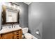 Cozy half bathroom with wood vanity and stylish light fixture at 2539 Sagebrush Trl, Buford, GA 30519