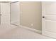 Carpeted bedroom with closet, white door and neutral wall color at 2539 Sagebrush Trl, Buford, GA 30519