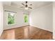 Bedroom with hardwood floors, tray ceiling, and views of the lush, green yard at 2539 Sagebrush Trl, Buford, GA 30519