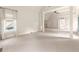 Large, carpeted bedroom featuring tray ceilings, many white columns, and natural light at 2539 Sagebrush Trl, Buford, GA 30519