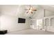 Carpeted bedroom featuring a vaulted ceiling with a flat-screen TV, french doors and built-in shelving at 2539 Sagebrush Trl, Buford, GA 30519