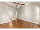 Bedroom with hardwood floors, tray ceiling, and access to the en suite bathroom at 2539 Sagebrush Trl, Buford, GA 30519