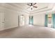 Spacious bedroom with coffered ceilings, neutral carpet, and large windows with blue curtains at 2539 Sagebrush Trl, Buford, GA 30519