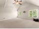 A carpeted bedroom featuring a vaulted ceiling with two windows allowing natural light at 2539 Sagebrush Trl, Buford, GA 30519