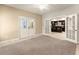 Bonus room featuring double doors with carpet flooring and an open view to the finished basement bar at 2539 Sagebrush Trl, Buford, GA 30519