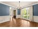 Dining room featuring wainscoting, blue walls, and natural light from large window at 2539 Sagebrush Trl, Buford, GA 30519