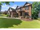 Stately brick home with lush green lawn and landscaped garden beds at 2539 Sagebrush Trl, Buford, GA 30519