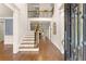 Bright foyer with hardwood floors, grand staircase, and elegant iron railing at 2539 Sagebrush Trl, Buford, GA 30519