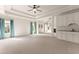 Expansive living room with coffered ceilings, a wet bar, a fireplace, and large windows at 2539 Sagebrush Trl, Buford, GA 30519