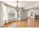 Open living room with fireplace, large windows, and hardwood flooring at 2539 Sagebrush Trl, Buford, GA 30519