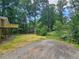 Beautiful backyard features a lush wooded area, deck, and parking area at 312 N Briar Rdg, Woodstock, GA 30189