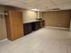 This basement features tile flooring, built-in cabinets, and ample storage space at 312 N Briar Rdg, Woodstock, GA 30189