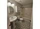 Bathroom featuring patterned floors, a pedestal sink, and a shower-tub combo at 312 N Briar Rdg, Woodstock, GA 30189
