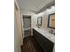 Well-lit bathroom featuring dual sinks, stylish mirrors, and a tiled shower at 312 N Briar Rdg, Woodstock, GA 30189