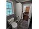 Bathroom features updated fixtures, including the toilet and storage cabinet at 312 N Briar Rdg, Woodstock, GA 30189