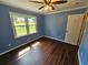 Comfortable bedroom featuring hardwood floors, blue walls, and a bright window at 312 N Briar Rdg, Woodstock, GA 30189