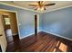 Cozy bedroom with dark wood floors, a ceiling fan, and plenty of natural light at 312 N Briar Rdg, Woodstock, GA 30189