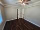 Comfortable bedroom featuring hardwood floors, modern ceiling fan, and two closets at 312 N Briar Rdg, Woodstock, GA 30189