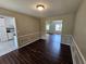 Open dining room featuring dark hardwood floors, decorative wainscoting, and natural light at 312 N Briar Rdg, Woodstock, GA 30189