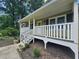 Charming front porch featuring white railing, neutral siding and professional landscaping at 312 N Briar Rdg, Woodstock, GA 30189