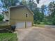 Exterior view of the home's two-car garage and rear balcony at 312 N Briar Rdg, Woodstock, GA 30189