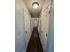 Long hallway with wood floors and multiple doors offering privacy to rooms at 312 N Briar Rdg, Woodstock, GA 30189