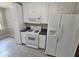 Functional kitchen with white appliances, ample storage, and durable countertops at 312 N Briar Rdg, Woodstock, GA 30189