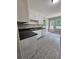 Bright kitchen with white cabinets, neutral countertops, and access to the outdoor deck at 312 N Briar Rdg, Woodstock, GA 30189