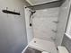 Updated bathroom with a tiled shower, glass shelving, and sleek fixtures at 312 N Briar Rdg, Woodstock, GA 30189