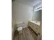 Bathroom features wood-look flooring, and a vanity with bright lighting at 504 Tracy Ct, Lawrenceville, GA 30046