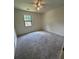 Bedroom has neutral carpet, ceiling fan, fresh paint, and a window at 504 Tracy Ct, Lawrenceville, GA 30046