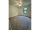 Bedroom features neutral carpet, a ceiling fan, a window, and fresh paint at 504 Tracy Ct, Lawrenceville, GA 30046