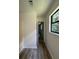Hallway with laminate floors, white walls, a window and open doorway to other rooms at 504 Tracy Ct, Lawrenceville, GA 30046