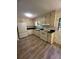 Kitchen featuring white appliances, cabinets, and new flooring at 504 Tracy Ct, Lawrenceville, GA 30046