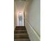 Stairway with neutral carpet and white walls leads to the upper level of the home at 504 Tracy Ct, Lawrenceville, GA 30046