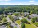 Picturesque aerial view featuring the community, pool, manicured lawns, and mature trees at 5228 Stone Village Circle Northwest #14 Nw Cir # 14, Kennesaw, GA 30152