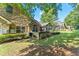 Lush backyard with stone and siding home exterior, showcasing landscaping and inviting outdoor space at 5228 Stone Village Circle Northwest #14 Nw Cir # 14, Kennesaw, GA 30152
