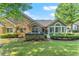 Charming backyard features stone and siding exterior, mature landscaping, and a cozy patio area at 5228 Stone Village Circle Northwest #14 Nw Cir # 14, Kennesaw, GA 30152