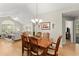Open-concept dining area with wood table, chandelier, and view into the living room at 5228 Stone Village Circle Northwest #14 Nw Cir # 14, Kennesaw, GA 30152