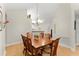 Dining room with wooden table, seating for eight, chandelier and hardwood floors at 5228 Stone Village Circle Northwest #14 Nw Cir # 14, Kennesaw, GA 30152