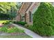 Charming home exterior with lush landscaping, stone facade, and manicured garden beds at 5228 Stone Village Circle Northwest #14 Nw Cir # 14, Kennesaw, GA 30152