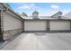 Attached two-car garage featuring a clean, spacious driveway and side stone details at 5228 Stone Village Circle Northwest #14 Nw Cir # 14, Kennesaw, GA 30152