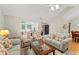 Bright living room with floral armchairs, neutral sofa, hardwood floors, and ample seating at 5228 Stone Village Circle Northwest #14 Nw Cir # 14, Kennesaw, GA 30152