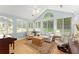 Light-filled sunroom with multiple windows, wood floors, comfortable seating, and neutral tones at 5228 Stone Village Circle Northwest #14 Nw Cir # 14, Kennesaw, GA 30152