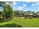 Lush backyard boasts expansive lawn, patio, and mature trees offering a serene retreat at 110 Village Ct, Woodstock, GA 30188