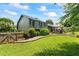 Lush backyard featuring mature trees and a manicured lawn at 110 Village Ct, Woodstock, GA 30188