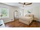 Bright bedroom with wood floors, two windows, and a comfortable bed with neutral bedding at 110 Village Ct, Woodstock, GA 30188
