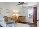 Cozy Bedroom with hardwood floors, a crib, changing table, and natural light from the window at 110 Village Ct, Woodstock, GA 30188