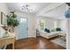 Bright foyer featuring hardwood floors and a charming accent wall, creating a welcoming first impression at 110 Village Ct, Woodstock, GA 30188